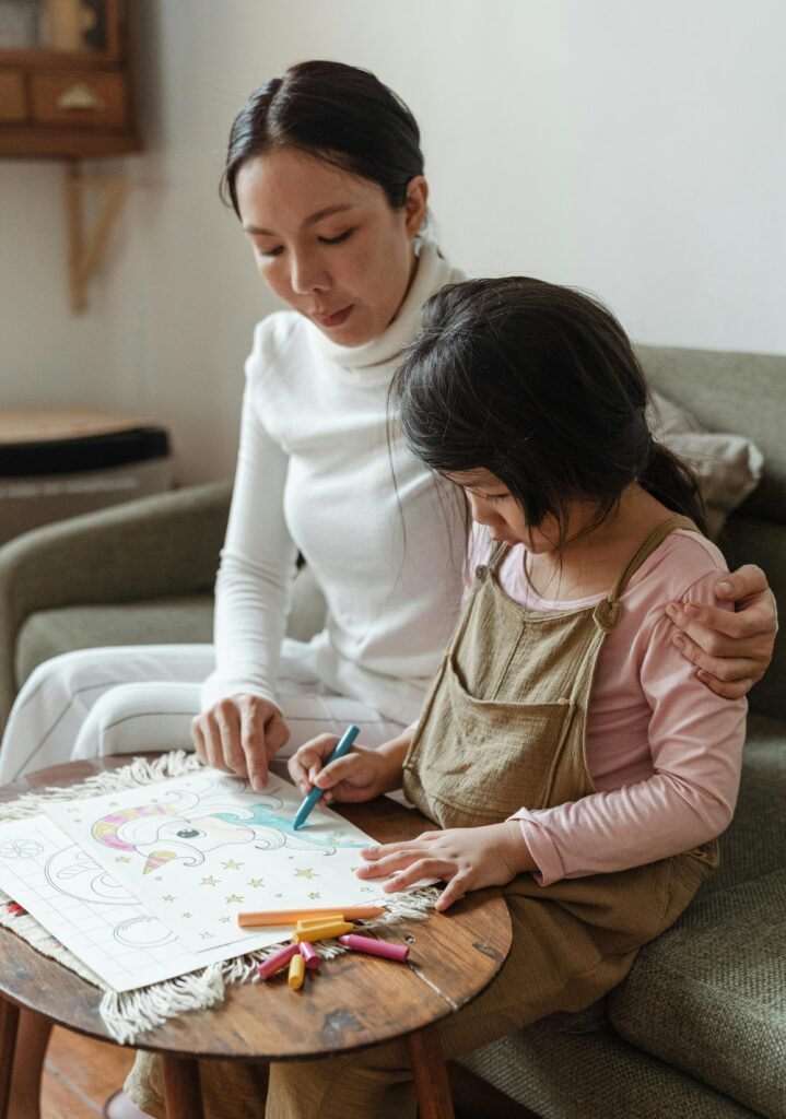 Mother and daughter enjoying a creative drawing session at home.