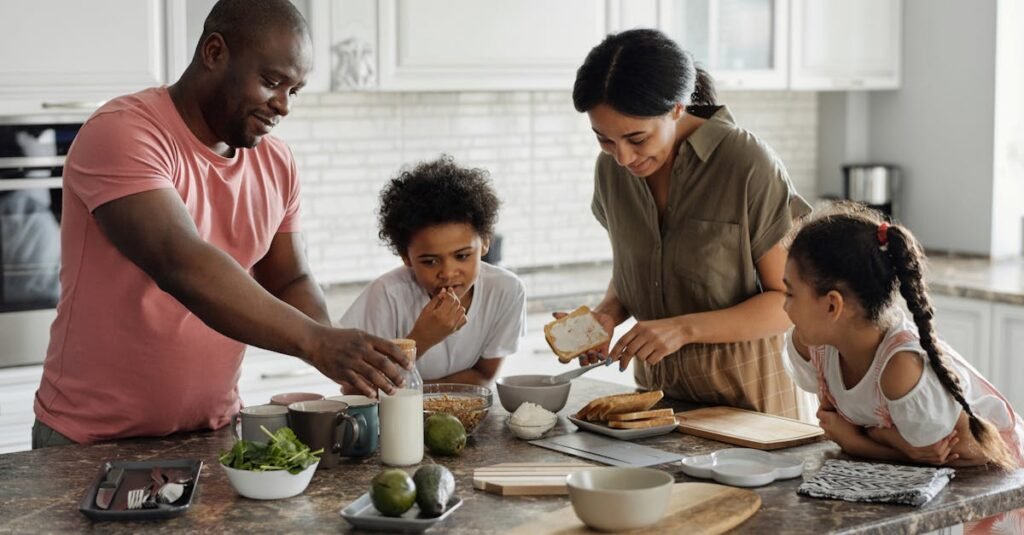 A joyful family enjoys preparing a healthy meal together in their modern kitchen.